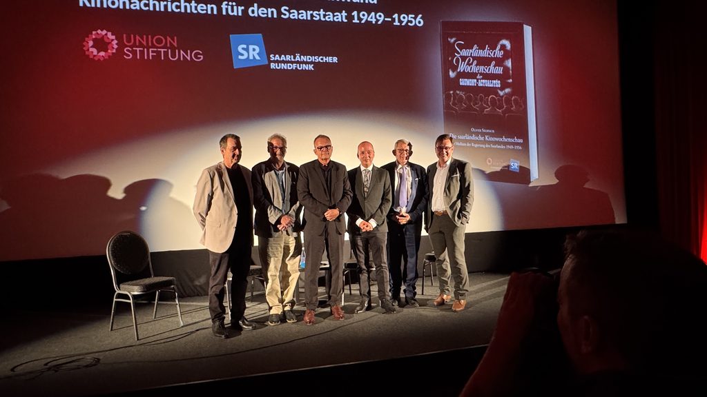 Martin Grasmück, Hans-Georg Warken, Oliver Siebisch, Paul Burgard, Hans-Christian Herrmann, Kay Hoffmann und Sarah Sassou bei der Veranstaltung zur Saarländischen Wochenschau